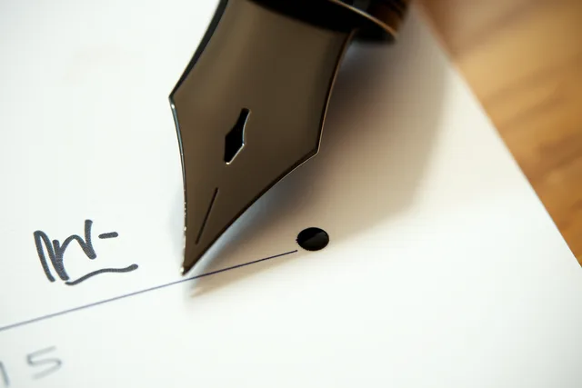 Fountain pen nib laying an ink line on sized notebook paper. Can you match a notebook to an ink without guessing at sizing?