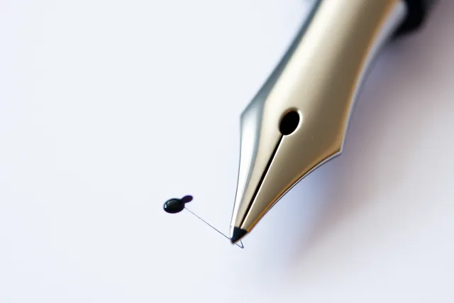 Two fountain pen nibs side by side drawing thin ink lines on white paper. Japanese vs Western Fountain Pen Nib Sizing: A Buyer's Guide